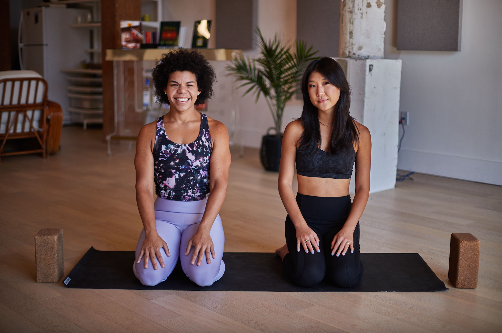 Angelina Fiorini Yoga Partnership with Reform Botanicals. Angie Fiorini and Sarah Choh on a yoga mat.