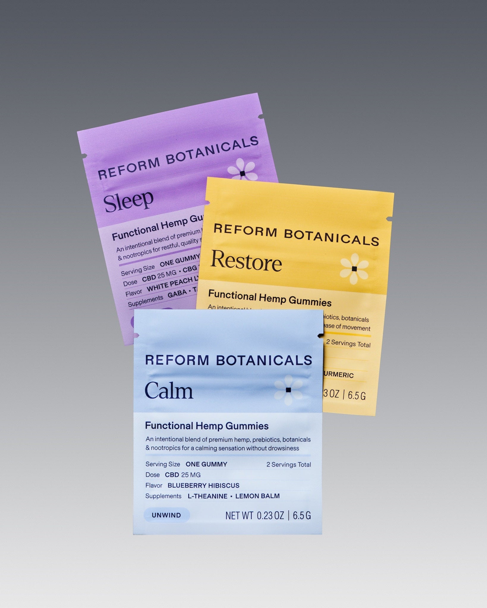 Three Reform Botanicals functional hemp gummies pouches in purple, yellow, and light blue, arranged in a fan shape on a gray gradient background.