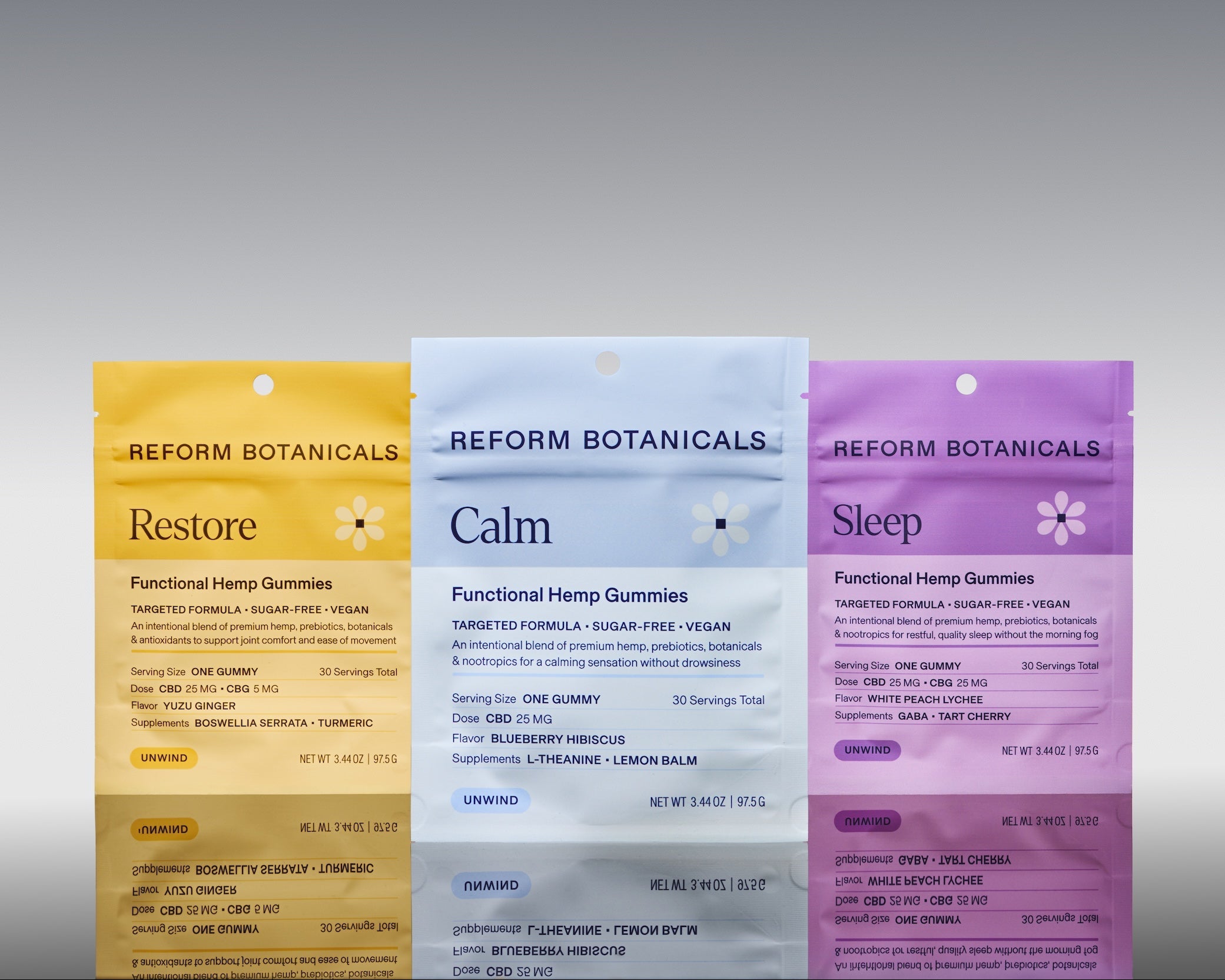 Three Reform Botanicals functional hemp gummies pouches in yellow, white, and purple, standing upright against a gray gradient background.