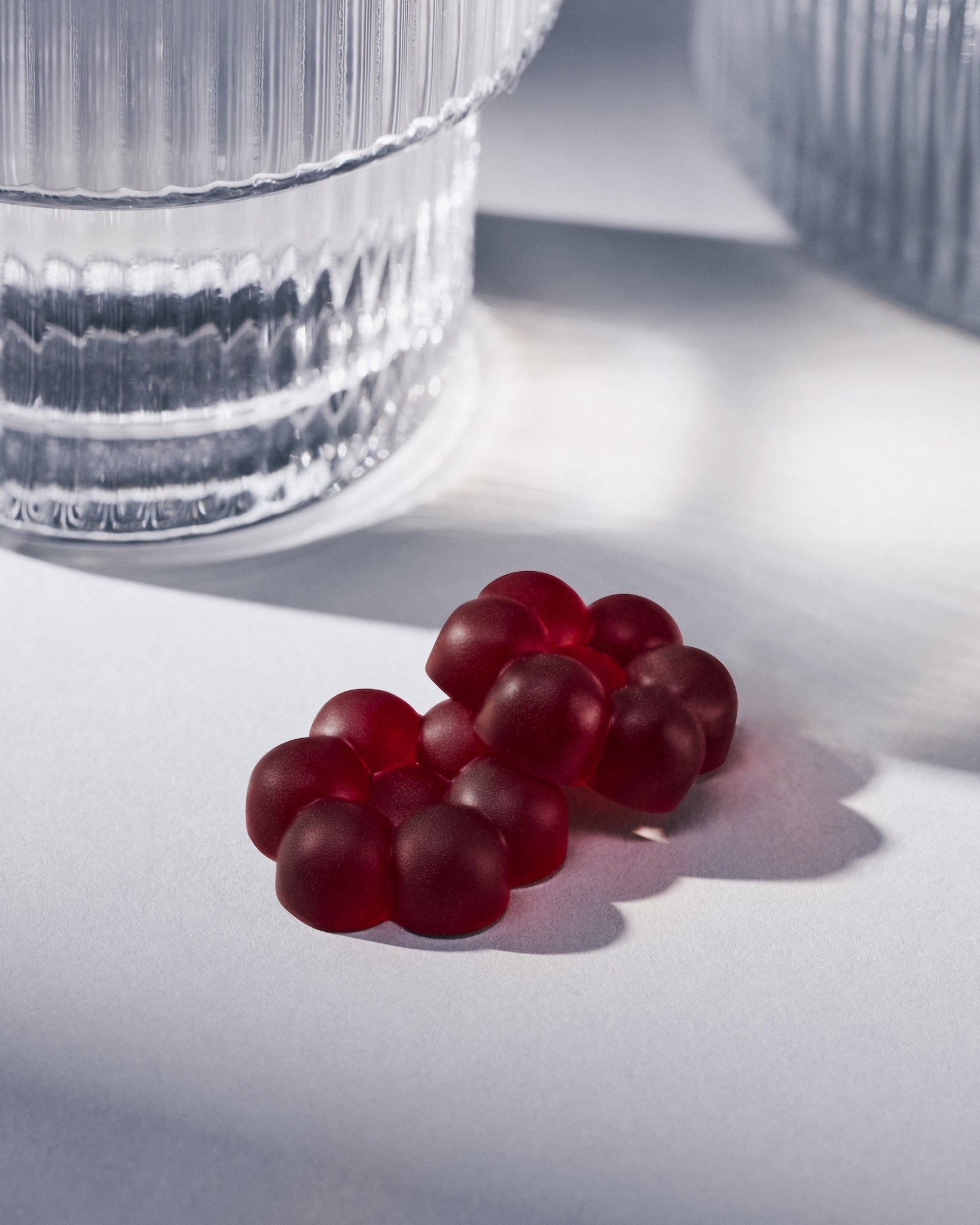 Reform Botanicals Functional Hemp Gummies, Calm, Blueberry Hibiscus with a glass of water